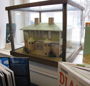 A tiny version of the Westport Library sits in a library window. 