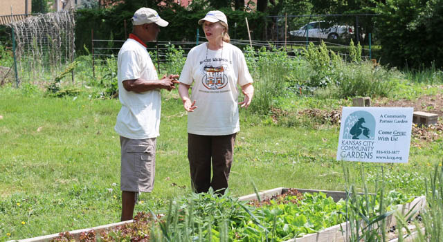 Susan Lackamp and Larry Thompson look over the community garden in  the Manheim neighborhood.