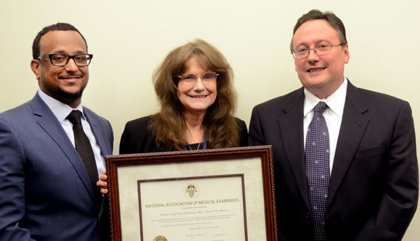 National Association of Medical Examiners Site Inspector Dr. Roger Mitchell (left) presented Jackson County Chief Medical Examiner Dr. Mary Dudley and County Executive Mike Sanders with the NAME accreditation certificate. The inspectors found no deficiencies. Courtesy Jackson County.  during the accreditation process. 