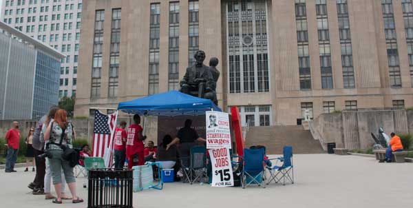 File photo. Supporters of a minimum wage hike camped out in front of City Hall in July, 2015. 