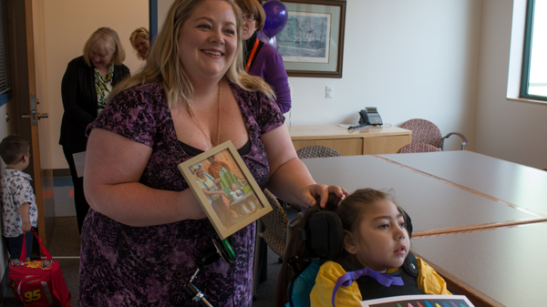 Katherine Talbot holds a photo of Terri LaManno and her daughter Layla.