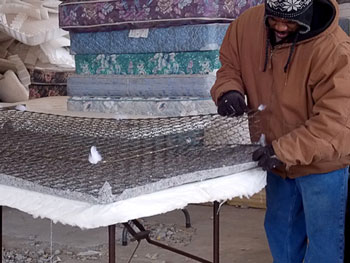 At the Avenue of Life facility, mattresses and box springs are dismantled by hand. Metal, wood, foam, polyester and cotton are reclaimed and sold to manufacturers for making new products. Photo courtesy Mid-America Regional Council. 