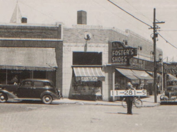 While this block around Westport Road and Main Street has changed since 1940, the building at this corner remains. Today it is home to Oddly Correct; in 1940, it was the location of a Foster’s Shoe Store. 