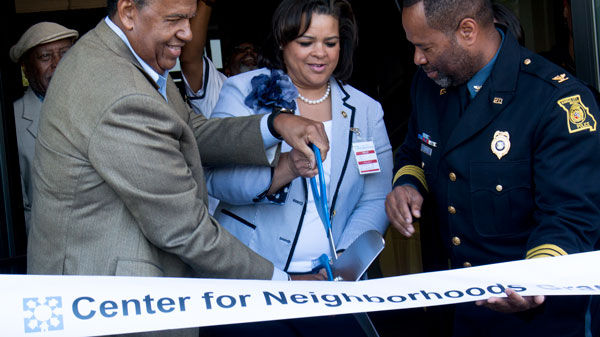UMKC Chancellor Leo Morton, State Senator Kiki Curls and Police Chief Darryl Forte cut the ribbon for the new Center for Neighborhoods at 4747 Troost on Saturday. 